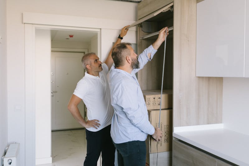men inspecting the cabinets